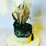 Cake decorated with palm spears and gold deco