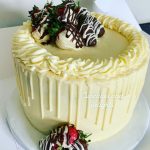 Buttercream cake decorated with chocolate covered strawberries